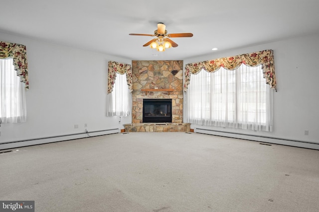 unfurnished living room featuring a fireplace, carpet, and a baseboard heating unit