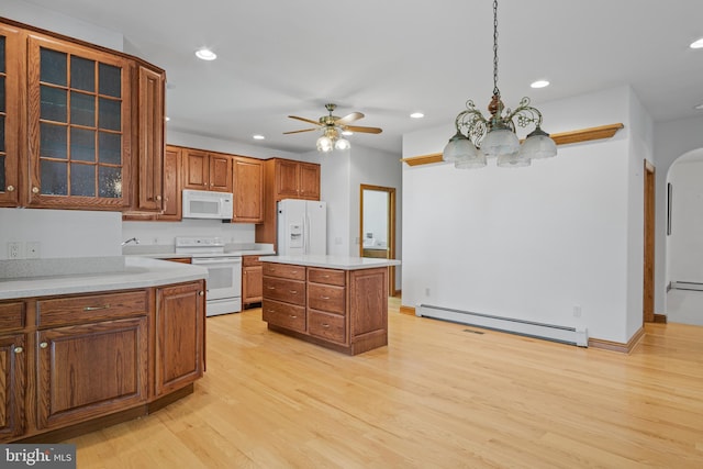 kitchen with pendant lighting, a center island, white appliances, a baseboard radiator, and light hardwood / wood-style floors