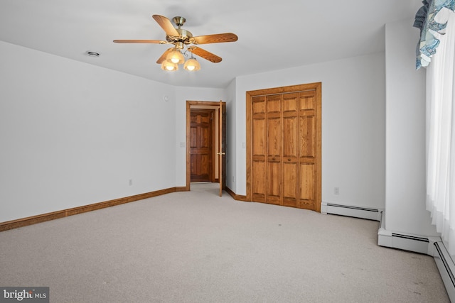 unfurnished bedroom featuring ceiling fan, a closet, light carpet, and a baseboard radiator