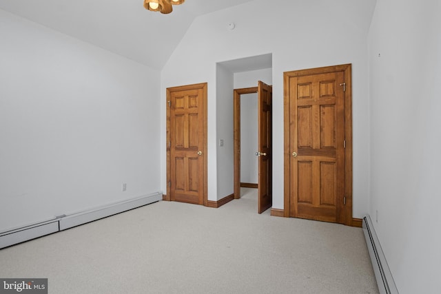 unfurnished bedroom with light colored carpet, vaulted ceiling, and a baseboard heating unit