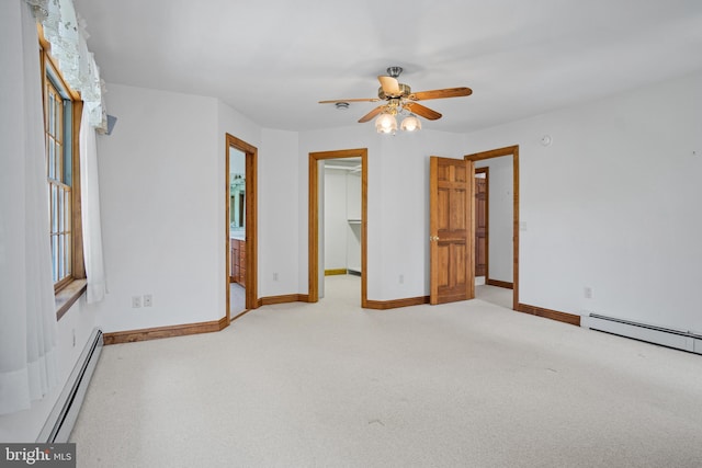 empty room featuring a baseboard radiator, ceiling fan, and light colored carpet