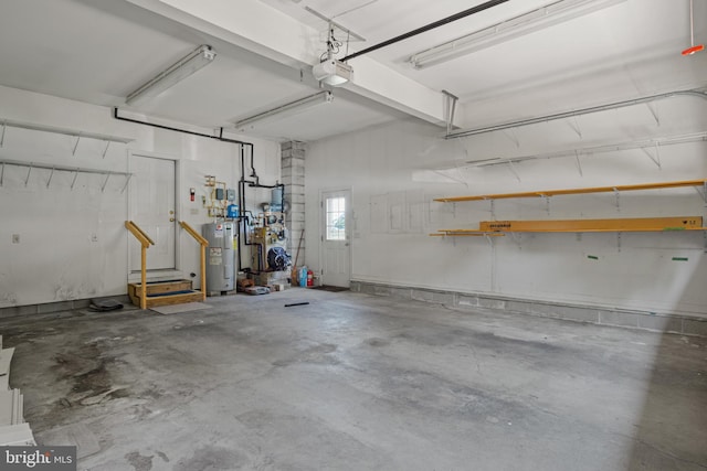 garage featuring electric water heater and a garage door opener