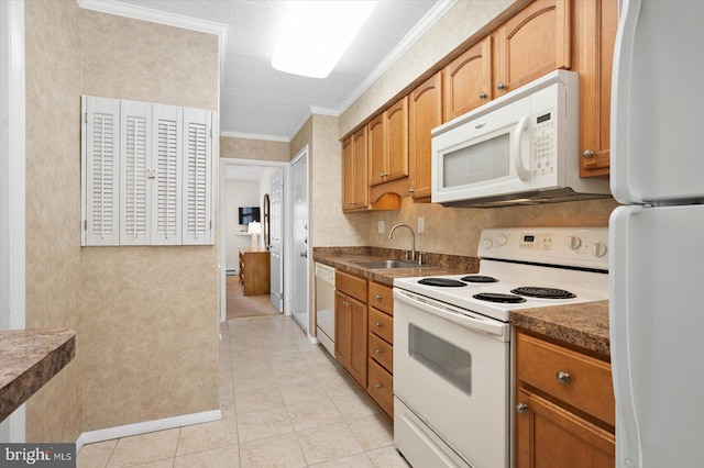 kitchen with sink, light tile patterned floors, crown molding, and white appliances