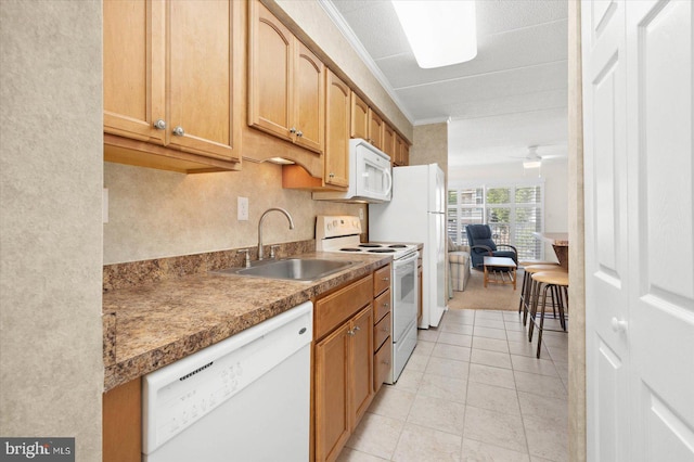 kitchen with light tile patterned flooring, white appliances, sink, and ornamental molding