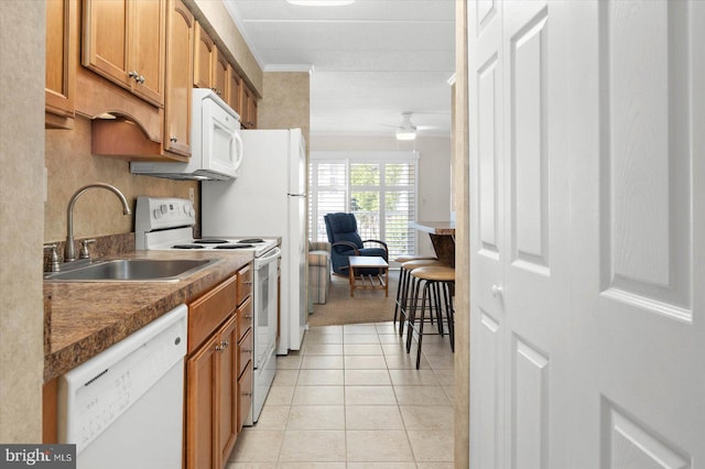 kitchen featuring light tile patterned flooring, sink, ceiling fan, and white appliances