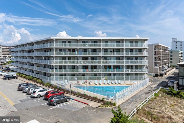 view of building exterior featuring a community pool