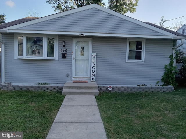 bungalow-style home featuring a front yard