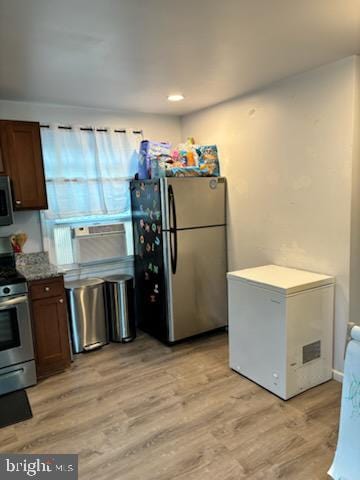 kitchen with stainless steel appliances and light wood-type flooring