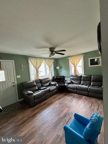 living room with hardwood / wood-style flooring, plenty of natural light, and ceiling fan