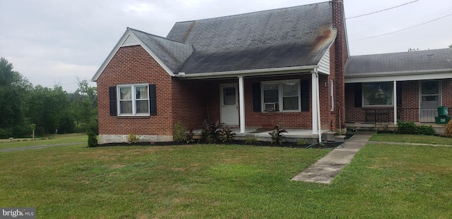 view of front of house with a front yard, covered porch, and cooling unit