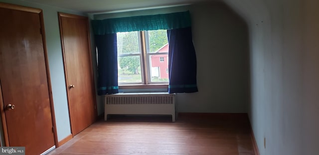 interior space with radiator and light wood-type flooring