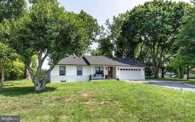 ranch-style house featuring a front yard and a garage