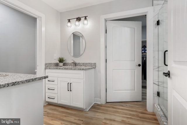 bathroom with vanity and hardwood / wood-style flooring