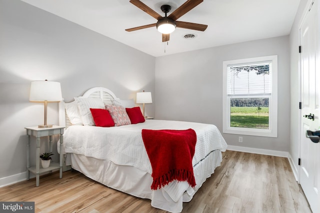 bedroom with ceiling fan and light hardwood / wood-style floors