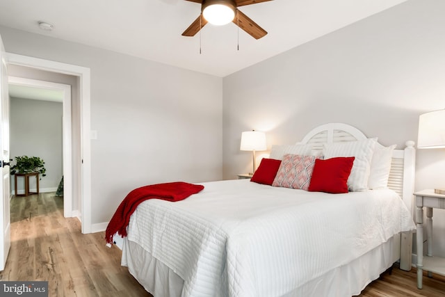 bedroom with ceiling fan and light hardwood / wood-style flooring