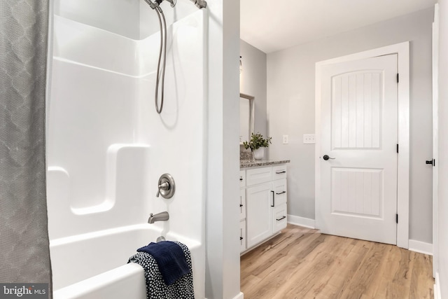 bathroom featuring vanity, shower / bath combination with curtain, and wood-type flooring