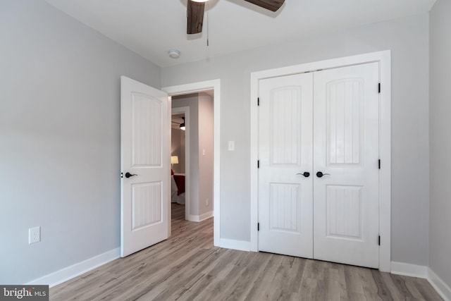 unfurnished bedroom featuring light hardwood / wood-style floors, a closet, and ceiling fan