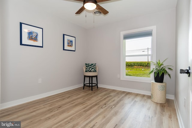 spare room with ceiling fan and light wood-type flooring