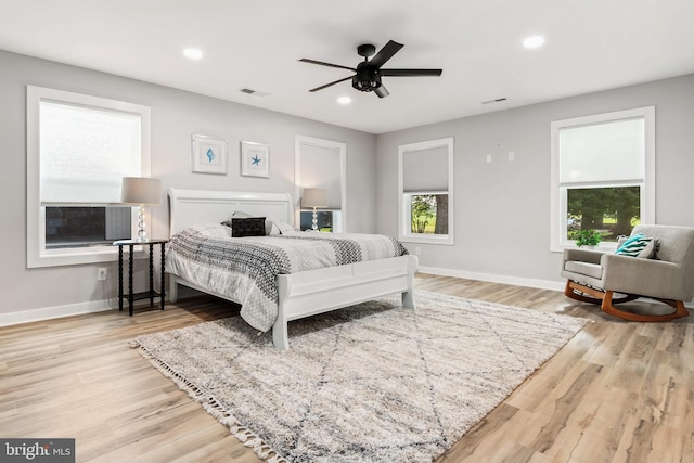 bedroom with light hardwood / wood-style floors and ceiling fan