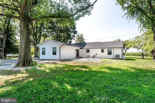 rear view of house featuring central AC, a yard, and a patio