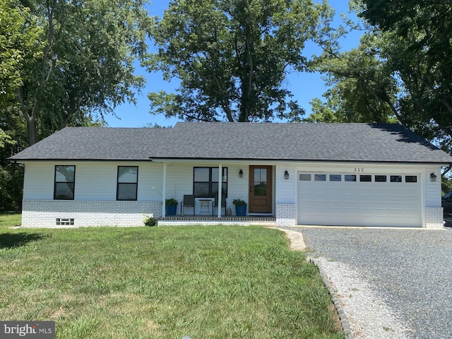 ranch-style house featuring a garage, covered porch, and a front lawn