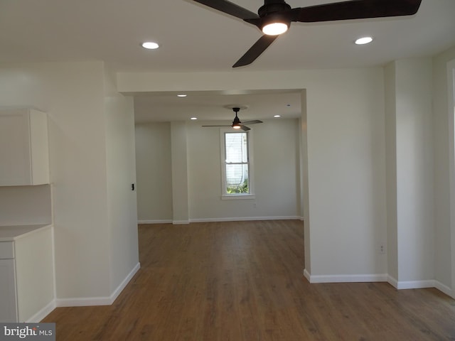 empty room with recessed lighting, baseboards, and wood finished floors