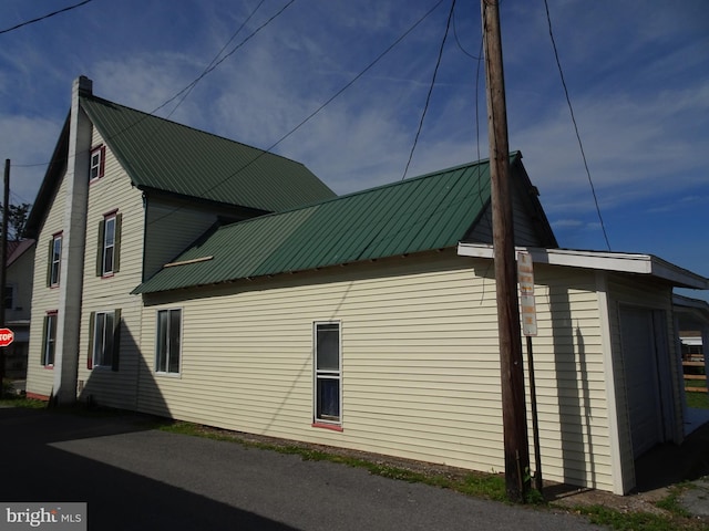 view of property exterior featuring metal roof