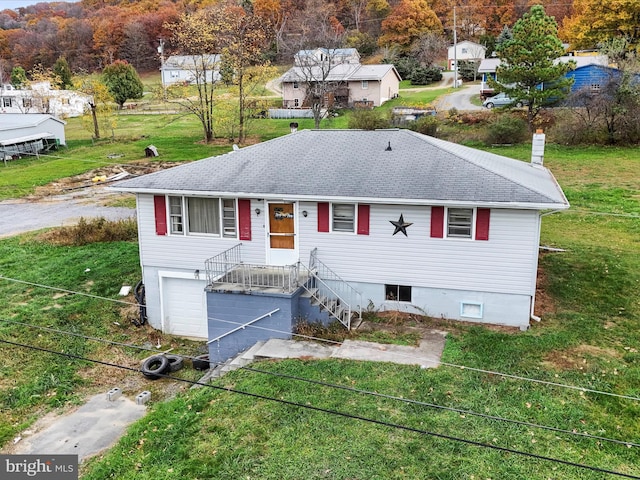 view of front facade with a garage and a front lawn