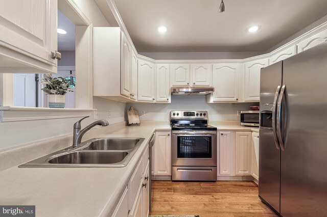 kitchen featuring sink, white cabinets, and appliances with stainless steel finishes