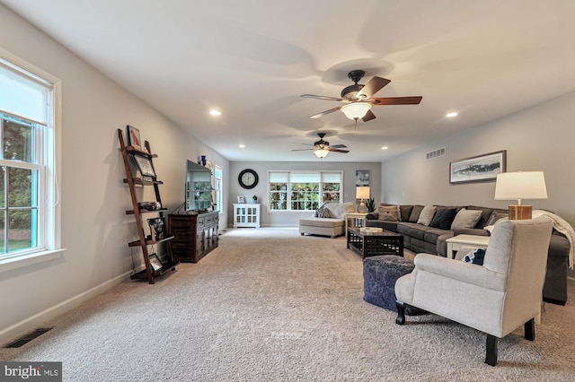 carpeted living room featuring ceiling fan