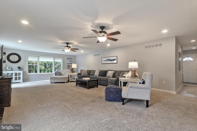 carpeted living room featuring ceiling fan