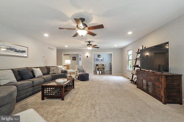 carpeted living room featuring ceiling fan