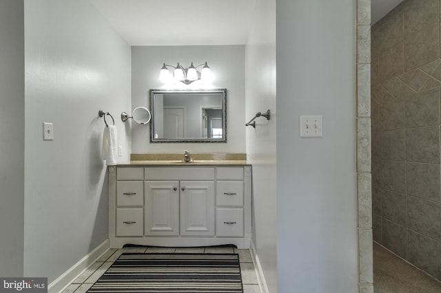 bathroom featuring tile patterned floors, vanity, and walk in shower