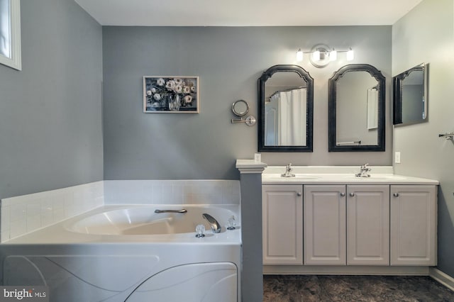 bathroom featuring vanity and a bath