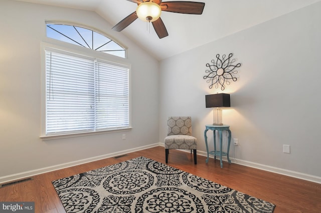 living area featuring hardwood / wood-style floors, ceiling fan, and lofted ceiling