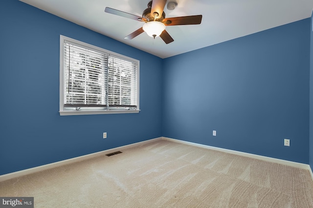 carpeted empty room featuring ceiling fan