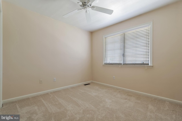 unfurnished room with ceiling fan and light carpet