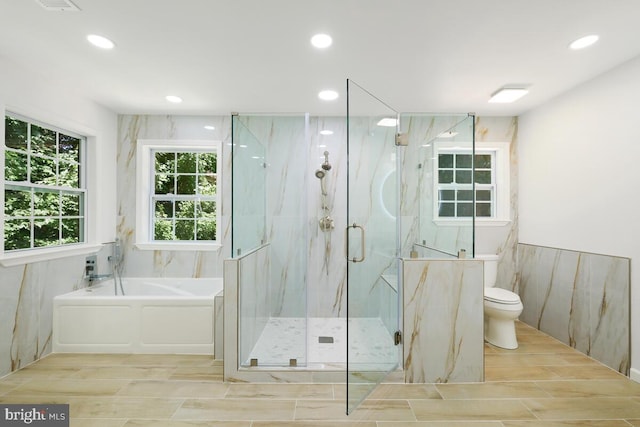 bathroom featuring toilet and separate shower and tub