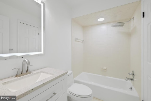 full bathroom featuring toilet, tiled shower / bath, and vanity