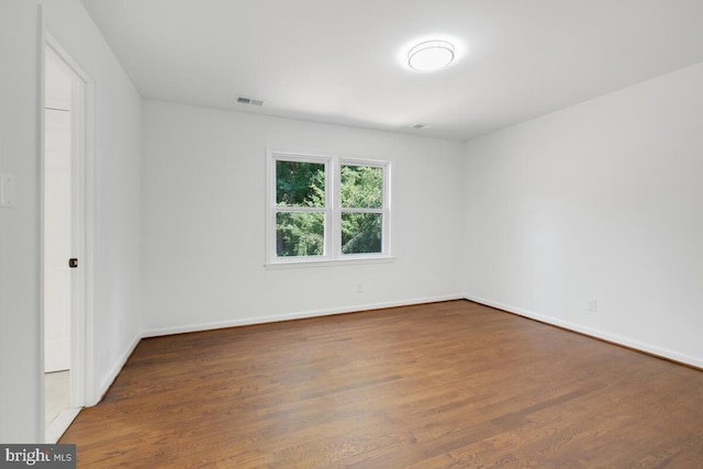 empty room featuring dark hardwood / wood-style flooring