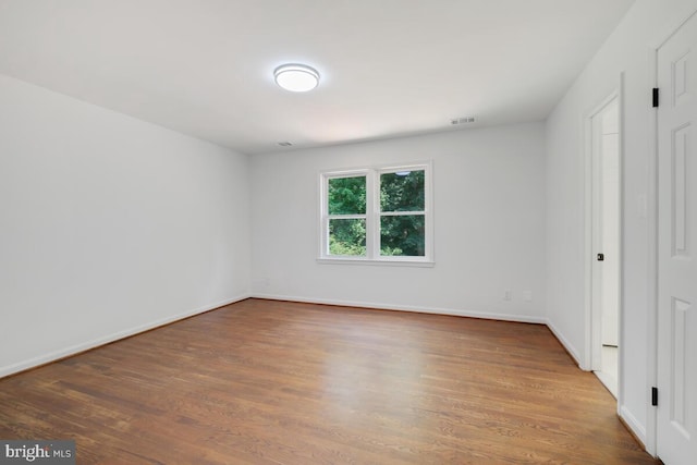 unfurnished bedroom with dark hardwood / wood-style floors