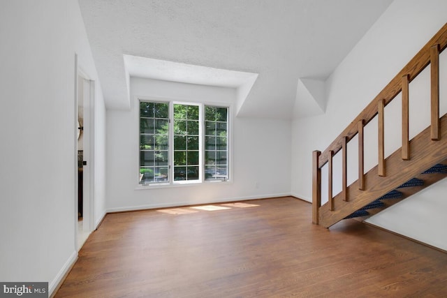 unfurnished living room featuring hardwood / wood-style floors