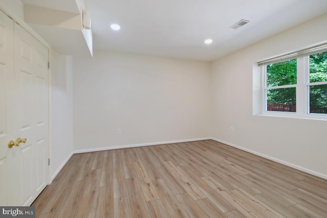 unfurnished room with light wood-type flooring