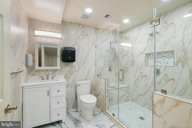 bathroom with toilet, tile walls, an enclosed shower, and vanity