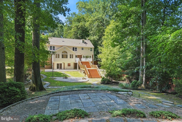 back of property featuring a yard and a patio