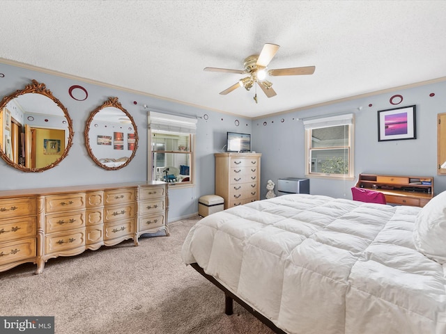 bedroom featuring a textured ceiling, light colored carpet, ceiling fan, and ornamental molding