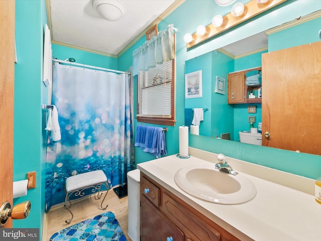 bathroom with hardwood / wood-style floors, vanity, toilet, and crown molding