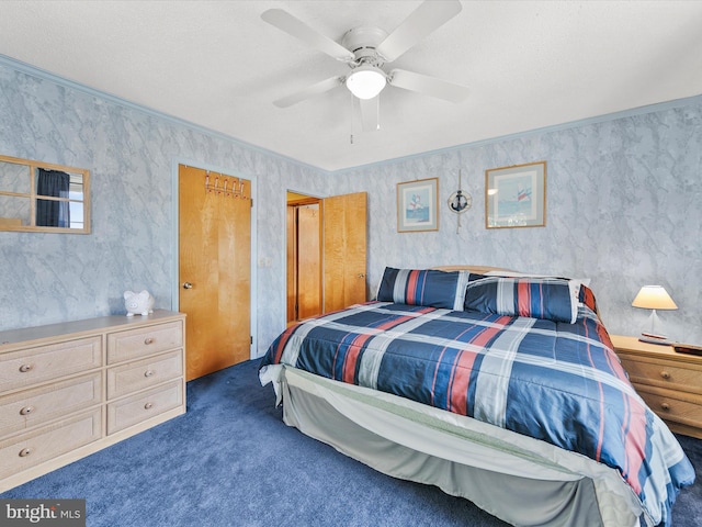 carpeted bedroom with a textured ceiling, ceiling fan, and crown molding