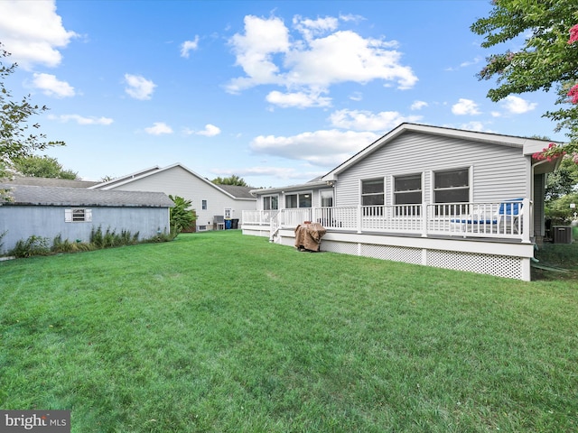 rear view of property with cooling unit and a lawn