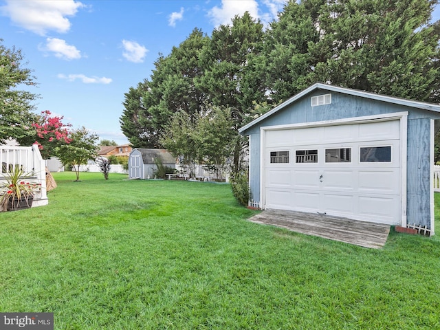 view of yard with a garage and a storage unit